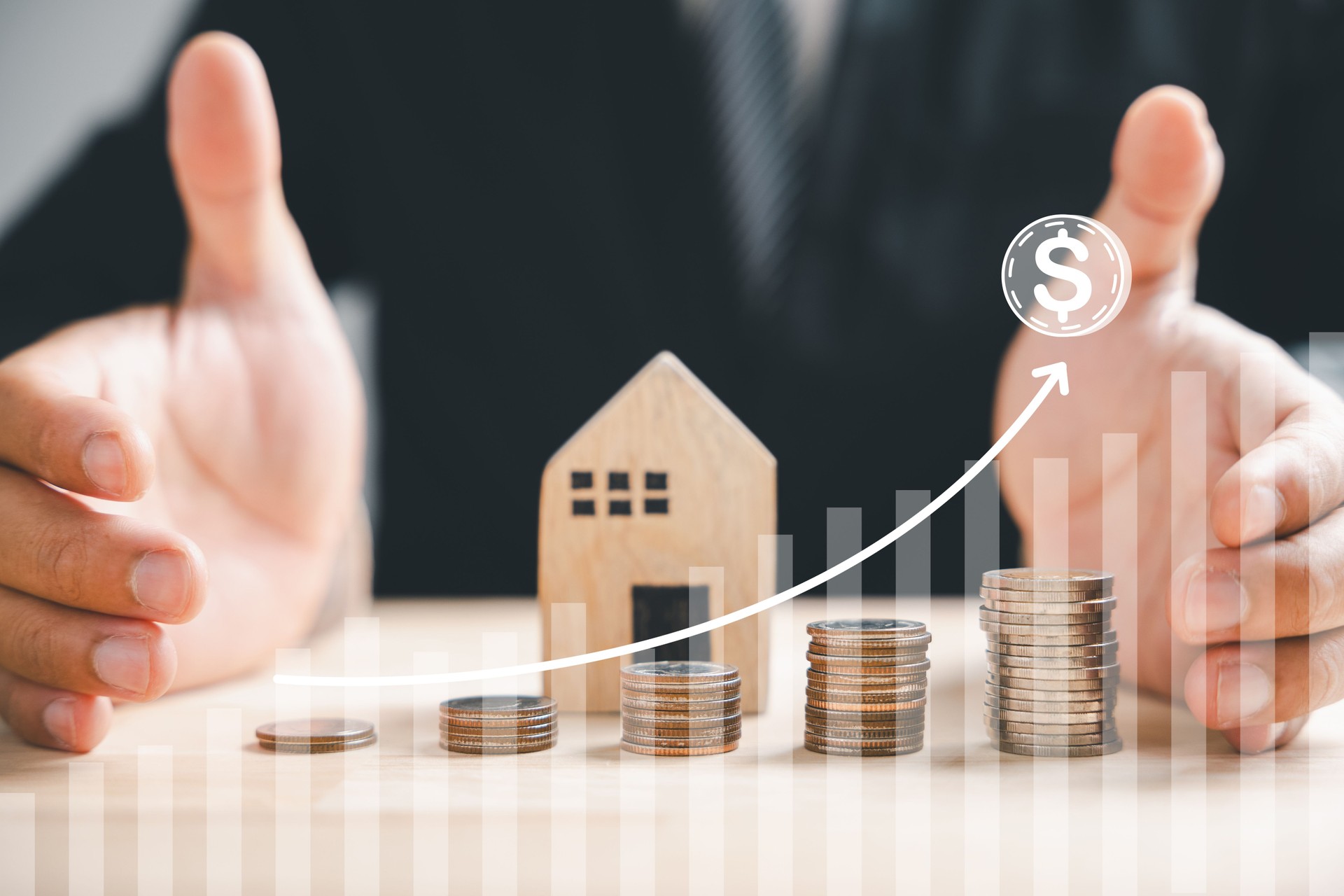 Businessman with house wooden and coin stack, real estate profit plan
